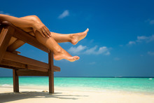 Young Woman Sunbathing On Lounger. Legs.