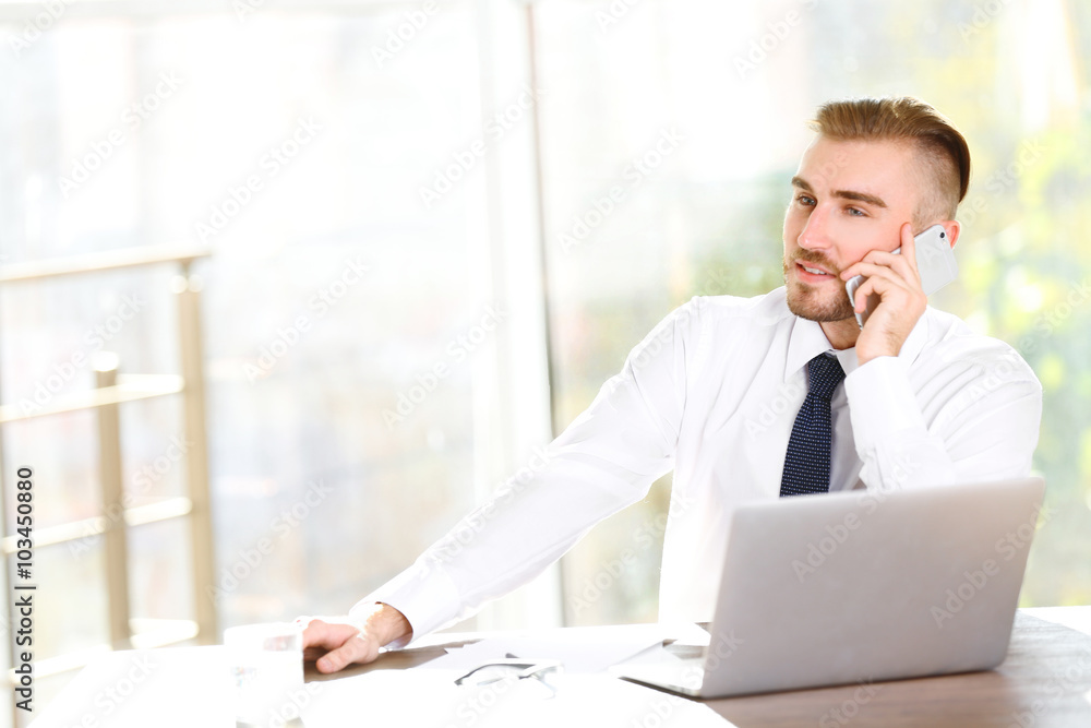 Businessman working with laptop in office