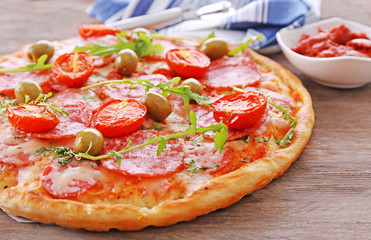 Delicious tasty pizza with ingredients on table, closeup