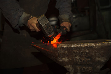 Blacksmith forfing hot iron