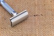 Razor on a burlap background with room for text