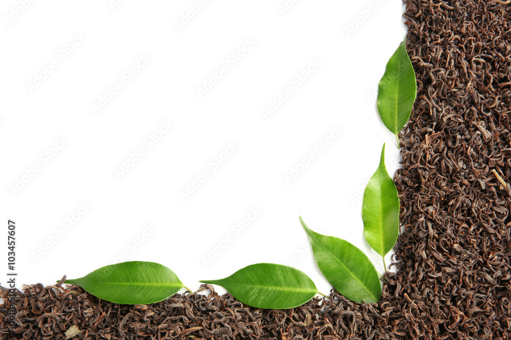 Frame of dry tea with green leaves, isolated on white