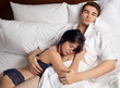Attractive Couple Cuddling in Bed