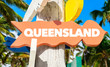 Queensland welcome sign with palm trees