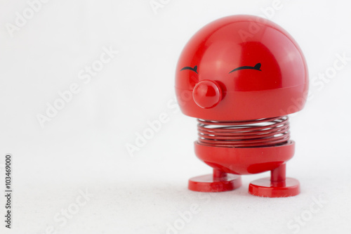 Fotografie, Obraz Red figure with metal spring laughing selective focus