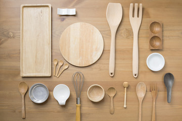 various kitchen utensils on wooden table background