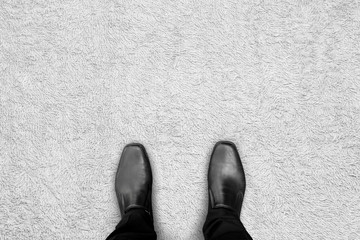 Wall Mural - Black shoes standing on the carpet