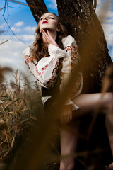 Young girl on the summer field  in national Belarus clothes, fas