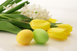 Easter still life : Yellow tulips, white hyacinth with yellow painted Easter eggs