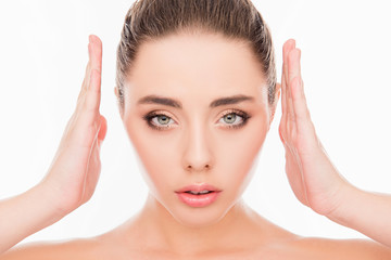 Close up portrait of minded woman holding hands near face and ma