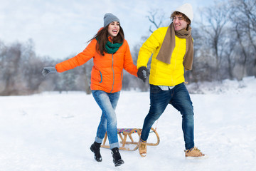 Wall Mural - Couple with sled in snow