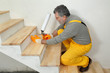 © sima - Home renovation, wooden stairs fix with polyurethane spray gun