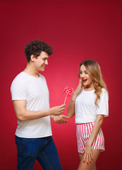 Wall Mural - Portrait of a Man and Woman in the style of pin-up with candy in