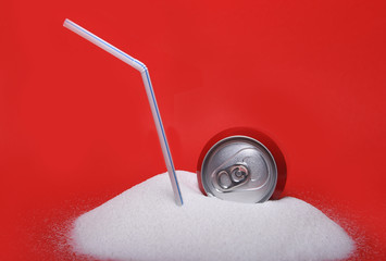 straw and cola refreshing drink can sitting in pure white sugar mountain