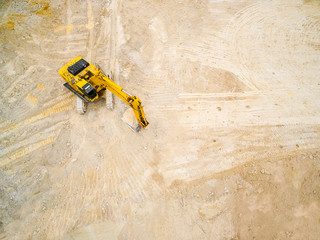 Wall Mural - Aerial view of working excavator in the opencast mine. Industrial background on digging theme. Use drones to inspect of your business. 