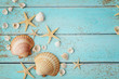 seashells and sand on wooden background