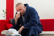 © fakezzz - Man having a cold holding tissue with box full of tissues