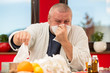 © fakezzz - Sick man suffering cold and winter flu virus drinking tea