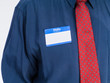 © chairboy - Photo of senior man in a blue shirt and red tie wearing a 'Hello My Name Is' name tag.