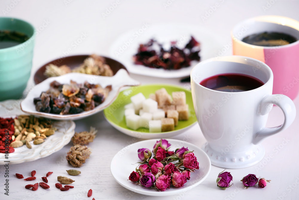 Cup of tea with aromatic dry tea on wooden background