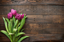 Pink, Tulips Bunch On Dark Barn Wood Planks Background. Space For Text, Copy, Lettering. Postcard Template.