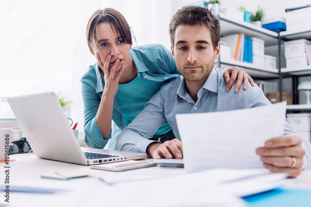 Couple checking bills at home