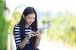 © stockphoto mania - asian girl and computer tablet in hand standing with toothy smil