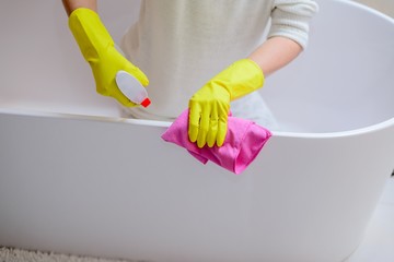 Wall Mural - Female hands with yellow rubber gloves cleaning bath