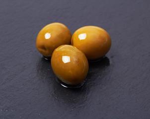 olives isolated on basalt