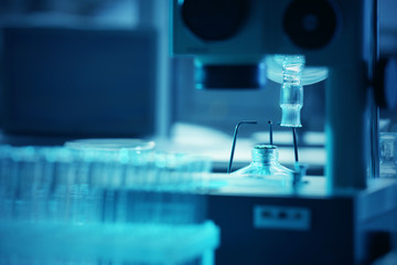 Wall Mural - microscope and glassware in laboratory closeup