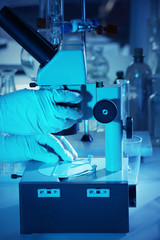 Wall Mural - scientist working with microscope closeup