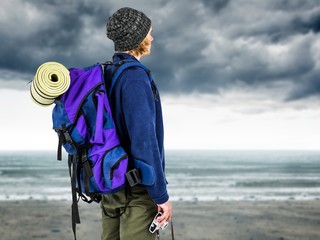 Wall Mural - Composite image of side view of backpacker hipster