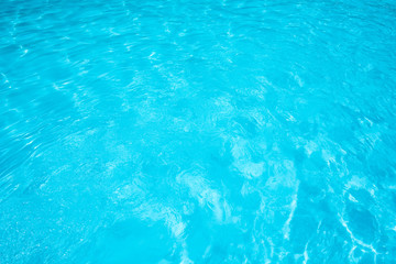 beautiful water surface in swimming pool with sun reflection