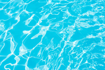 beautiful water surface in swimming pool with sun reflection