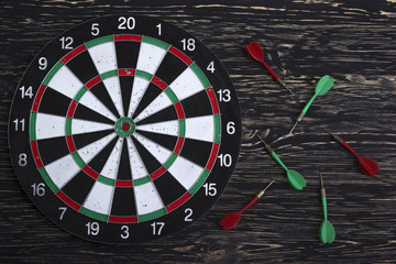 The darts isolated on wooden background