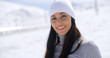 © Dash - Gorgeous young woman in winter fashion in a snowy landscape looking at the camera with a lovely warm friendly smile  with copy space