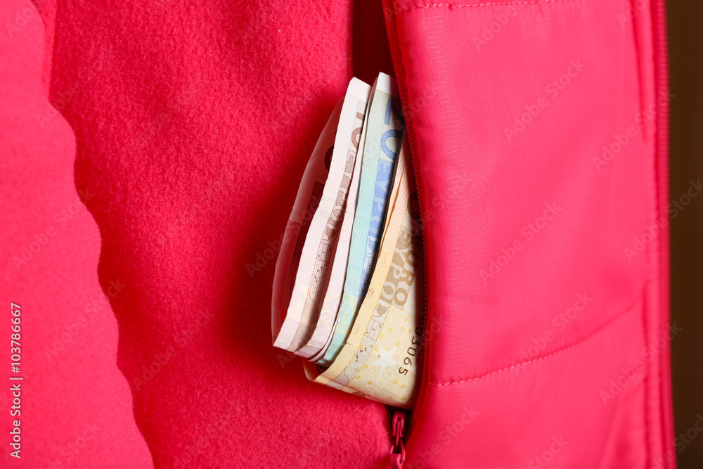 Cash in the red jacket pocket, close up