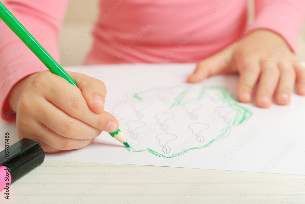 Child drawing tree with pencils on paper, closeup