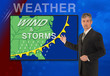 © Michael O'Keene - A tv television news weather meteorologist anchorman is reporting with a Wind & Storm graphic over a stormy black cloud photo on the monitor screen