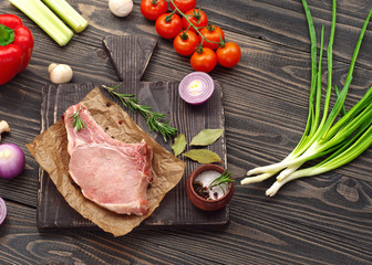 Canvas Print - Raw fresh piece of meat on the bone with vegetables