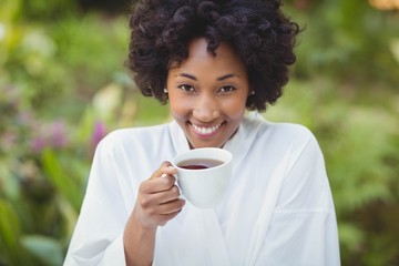 Smiling woman holding tea