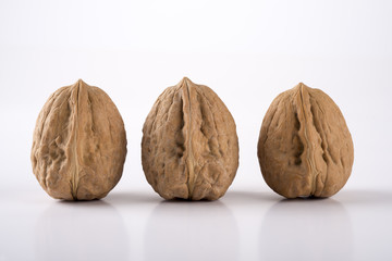 3 walnuts on a white background