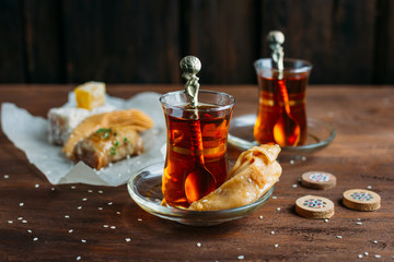 Turkish sweets and tea on a dark background