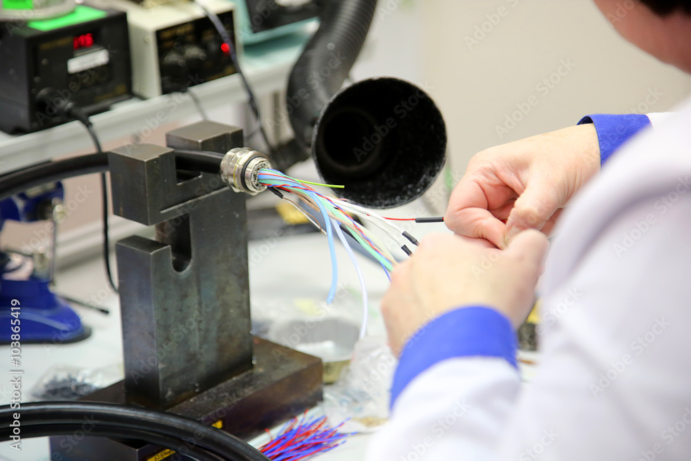 Wire Operator factory worker assembles the cable connections Stock Photo | Adobe Stock