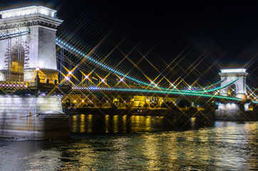 Canvas Print - Night view on Szechenyi Chain Bridge over Danube river in Budapest, Hungary. Cross Filter Effect