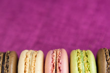 Boarder Of Macaroons On Pink Jute Tablecloth Closeup Space For Text