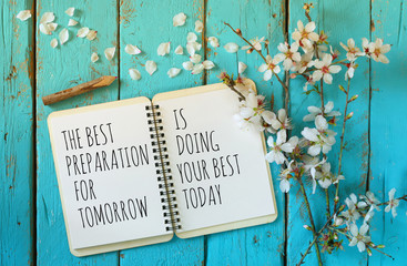 Wall Mural - open notebook over wooden table with motivational saying the best preparation for tomorrow is doing your best today
