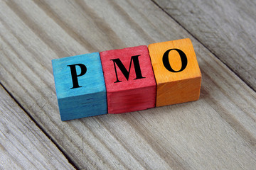 PMO (Project Management Office) acronym on colorful wooden cubes