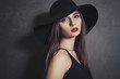 Fashion portrait of beautiful sexy young female in hat with red