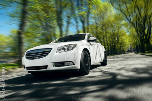 Fotografia, Obraz White car fast drive on asphalt road at daytime